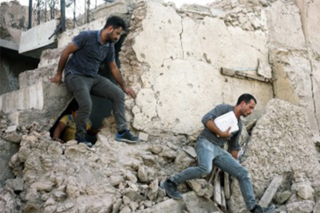 Ben Taub walking in building rubble